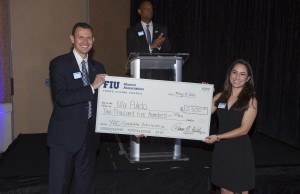 Hiram Hernandez (left) presents the Young Alumni Council Graduate Scholarship to recipient Ella Pulido (right). 